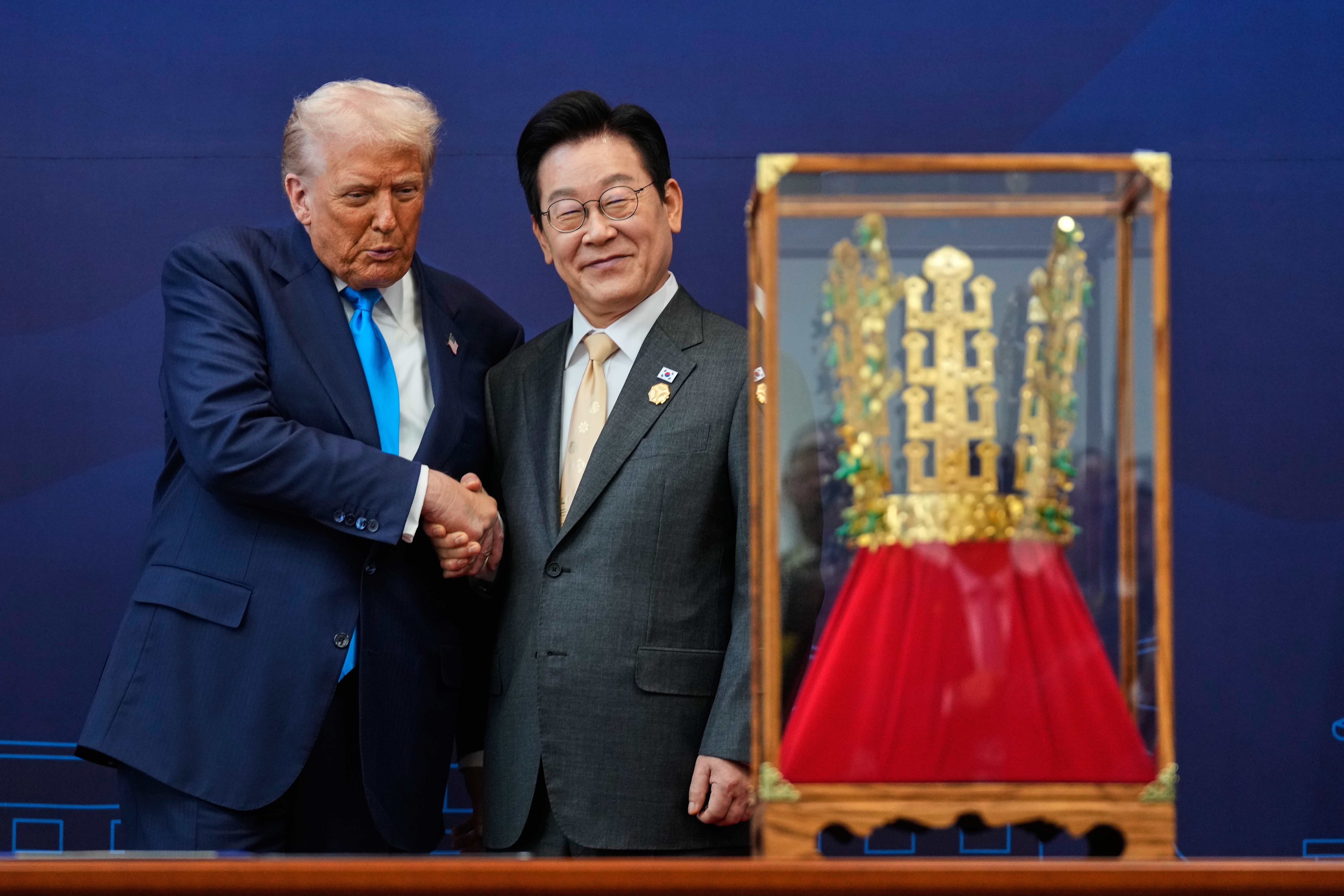 President Donald Trump shakes hands with South Korean President Lee Jae Myung as he receives a gift of a gold crown and an award of the Grand Order of Mugunghwa, not seen, during a high honor ceremony at the Gyeongju National Museum in Gyeongju, South Korea, Wednesday, Oct. 29, 2025.